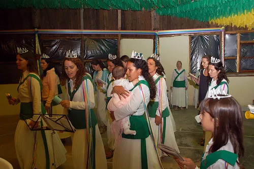 Members in ceremonial attire, singing together